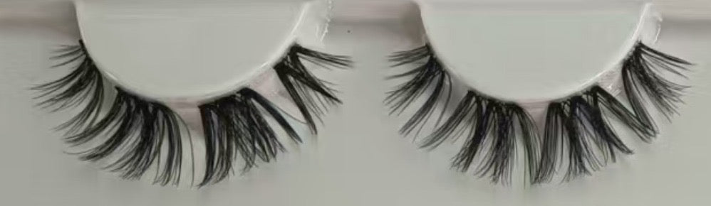 Close-up of Cowgirl 15mm D curl lash clusters. Flirty doll-eye DIY lash extensions with mega volume for at-home application using waterproof black glue.
