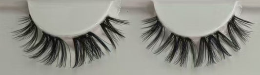 Close-up of Cowgirl 15mm D curl lash clusters. Flirty doll-eye DIY lash extensions with mega volume for at-home application using waterproof black glue.