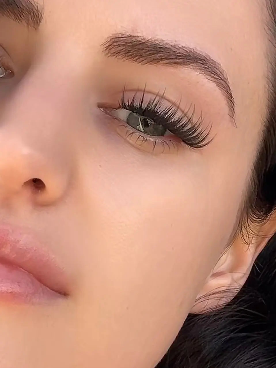 Model wearing Cowgirl lash clusters with 15mm wispy D curl. DIY lash extensions in doll-eye shape for bold, flirty country glam and long-lasting false lashes.